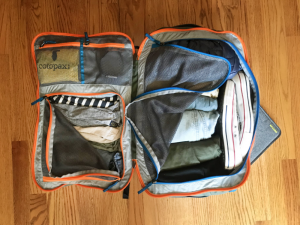 The Allpa 35L packed for a short weekend trip; laptop peeking out of rear side entrance sleeve. 